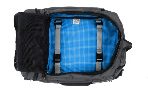 An open Techonaut 30 with a Nebulous Grey (dark grey) exterior and an Island (blue) interior.